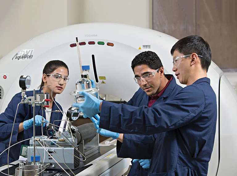 Imad A. Adel at a coreflood rig during gas-and-surfactant EOR testing.